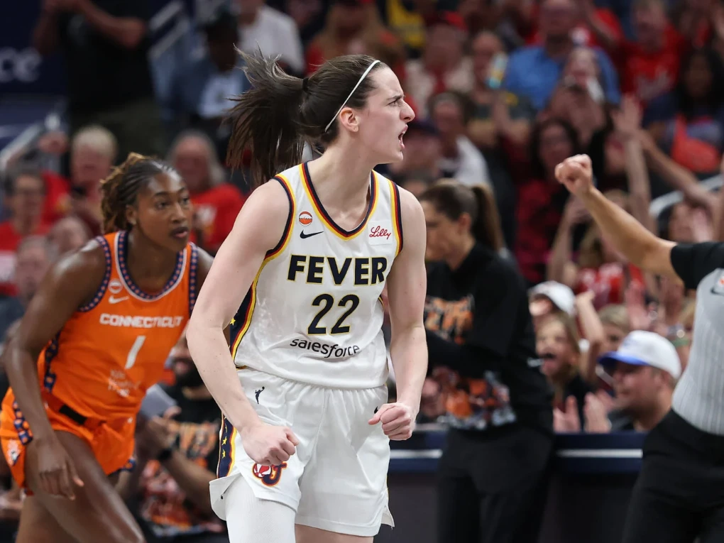 Kelsey Mitchell driving to the basket during an Indiana Fever WNBA game alongside teammate Aliyah Boston